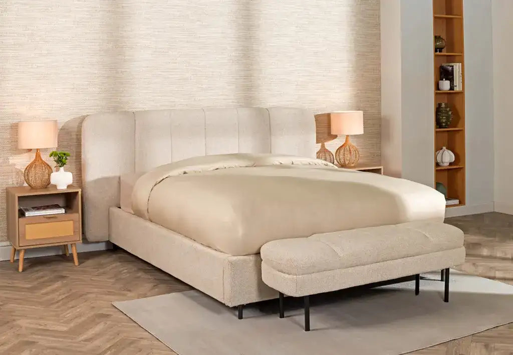 Beige upholstered bed with tufted headboard and matching bench.