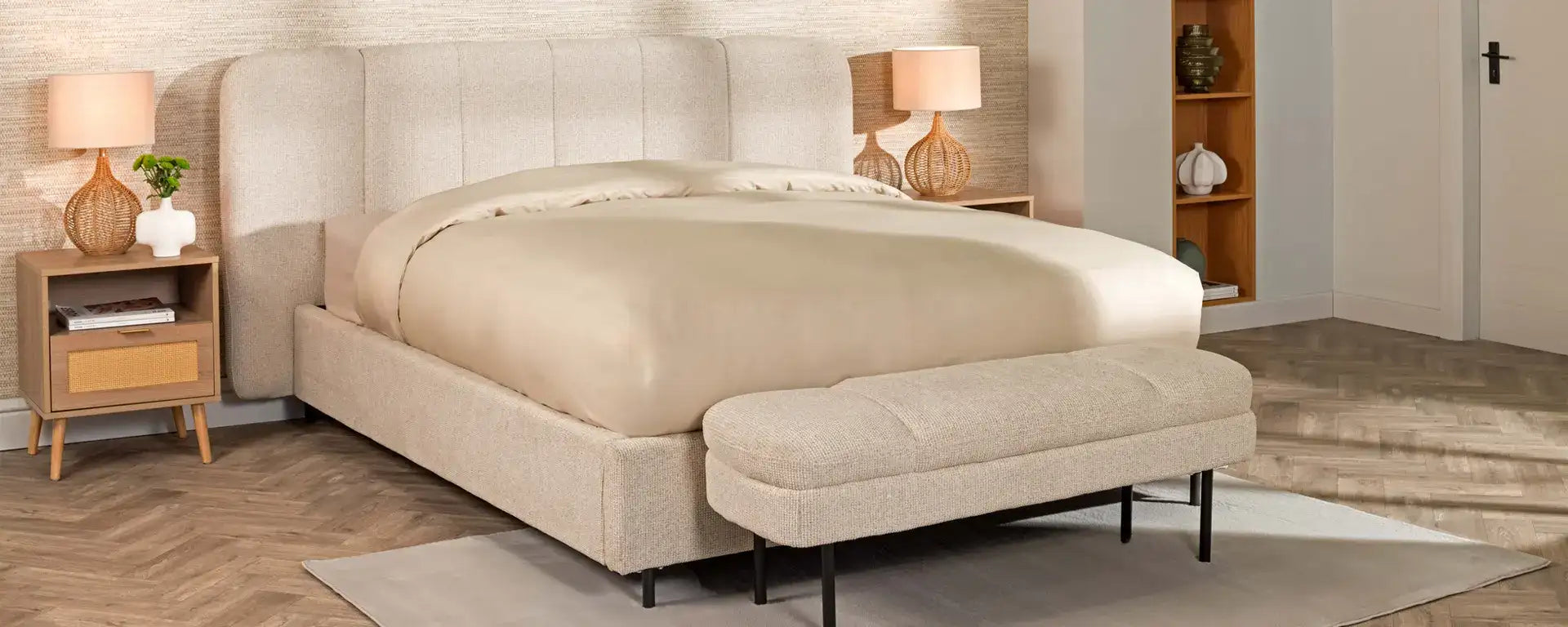 Beige upholstered platform bed with tufted headboard and matching bench.