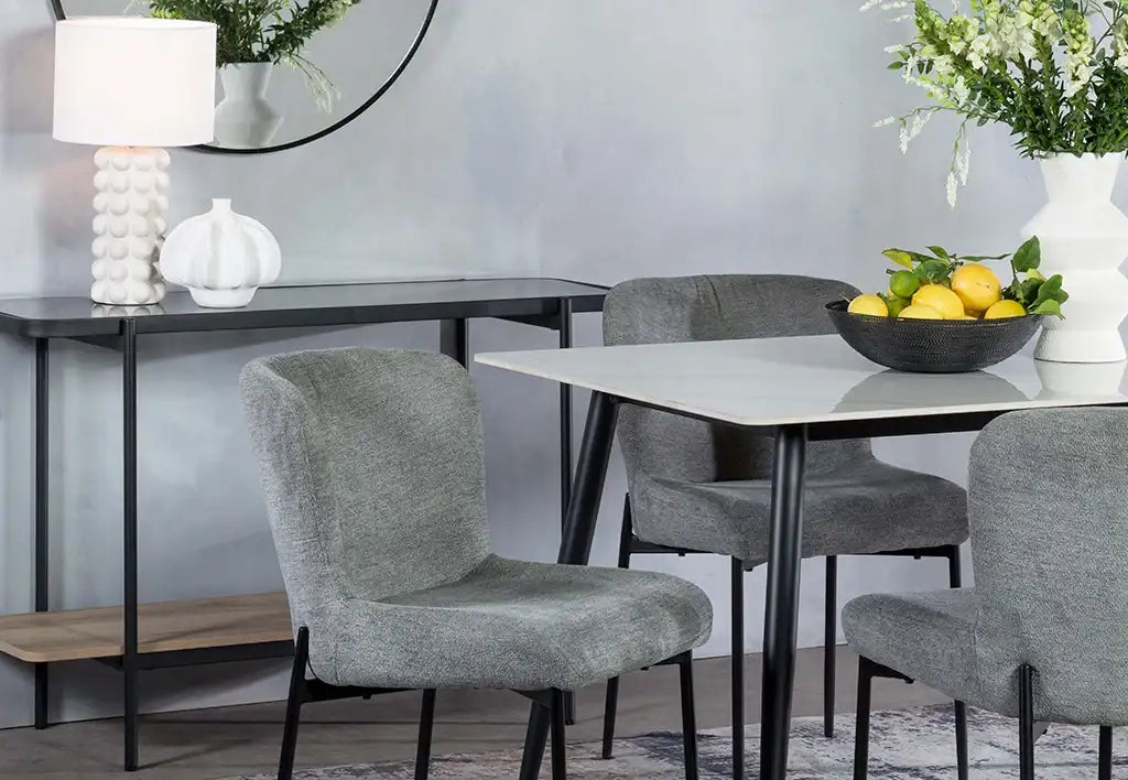 Gray upholstered dining chairs with black metal legs
